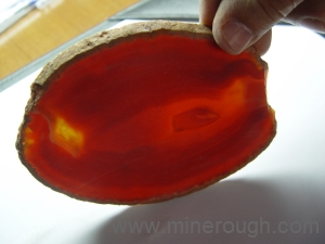 orange dyed banded agate sliced rough